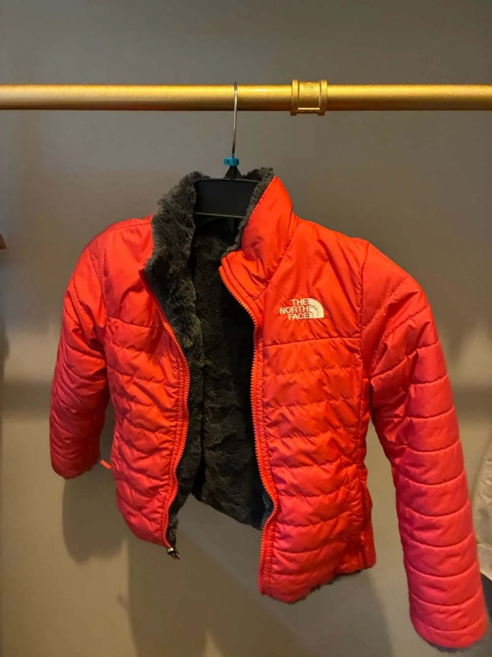 The North Face reversible Kids coral Jacket with Charcoal Fleece Interior.